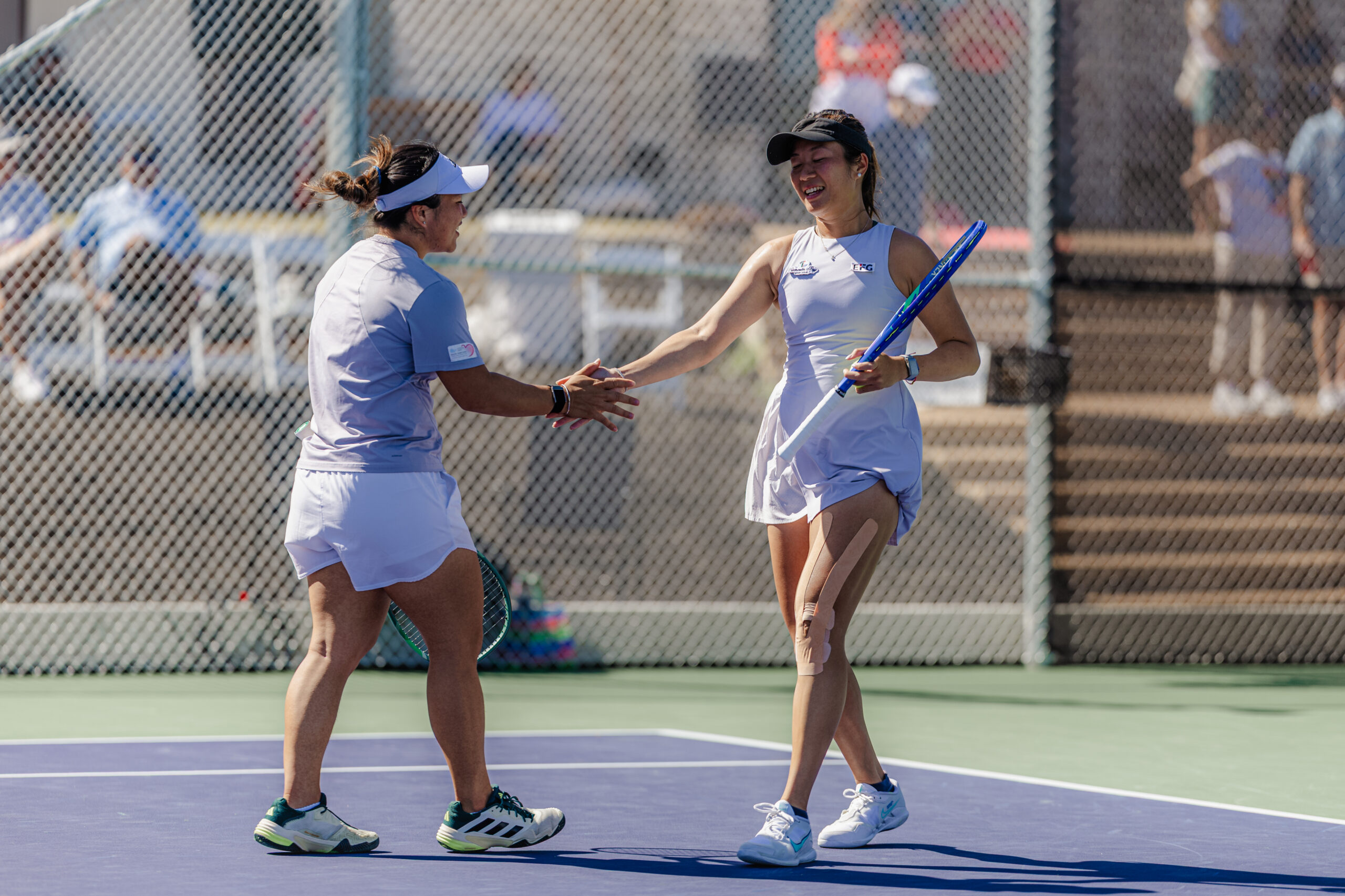 En-Shuo Liang, left, shakes hands with Eudice Chong after their doubles match.